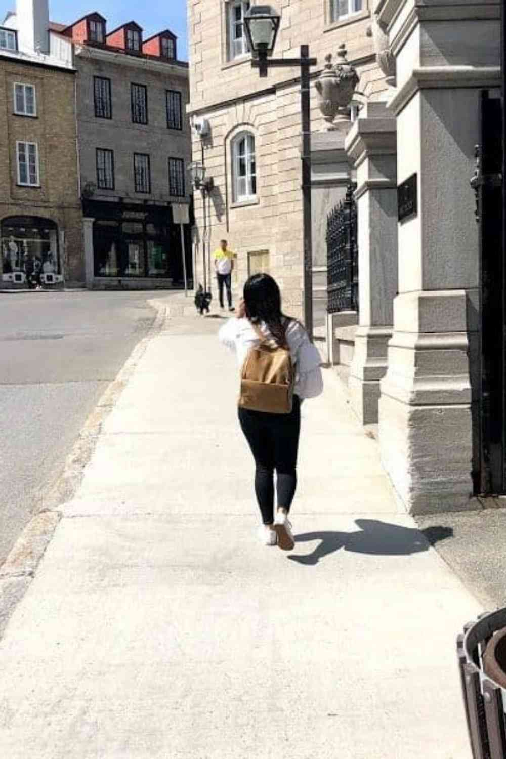 girl walking down a European street in Quebec City