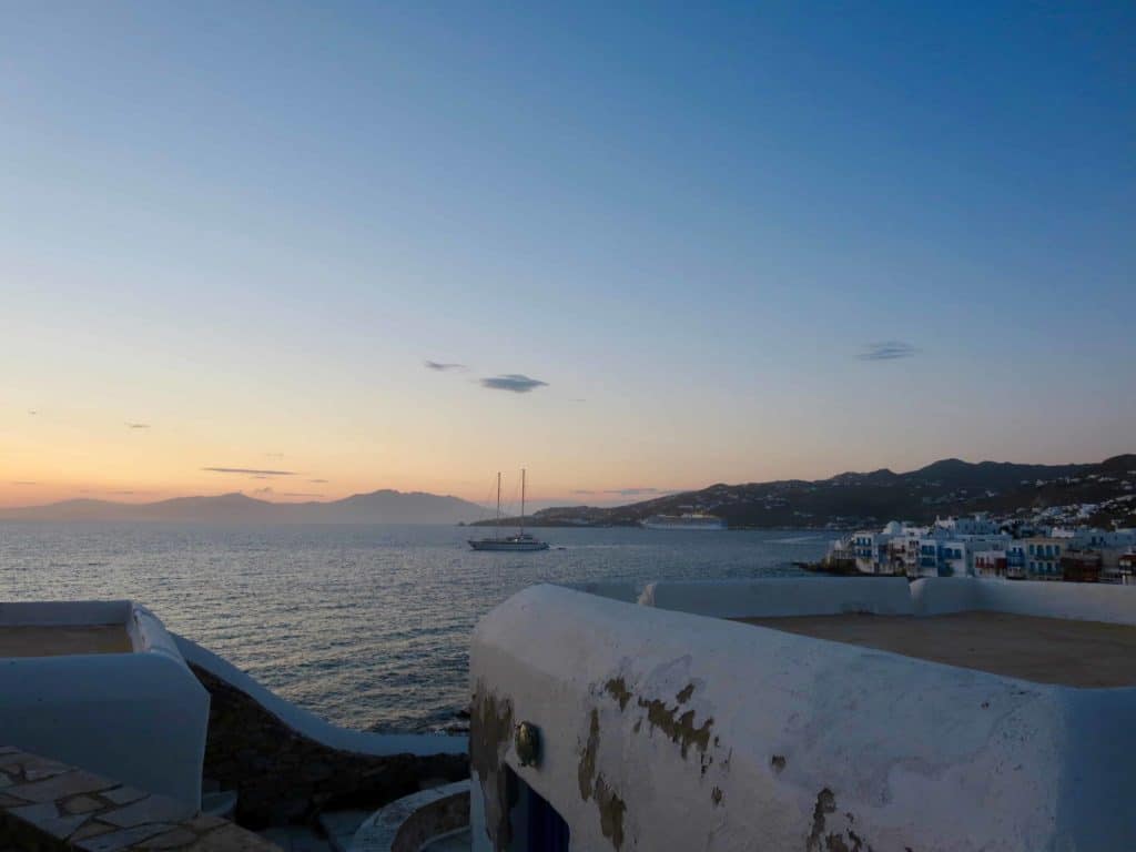 blue sea at sunset with white houses in Greek Island