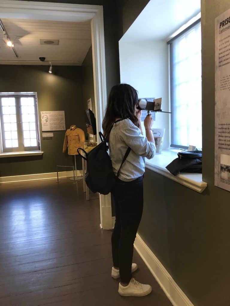 girl looking through bifocals at a museum