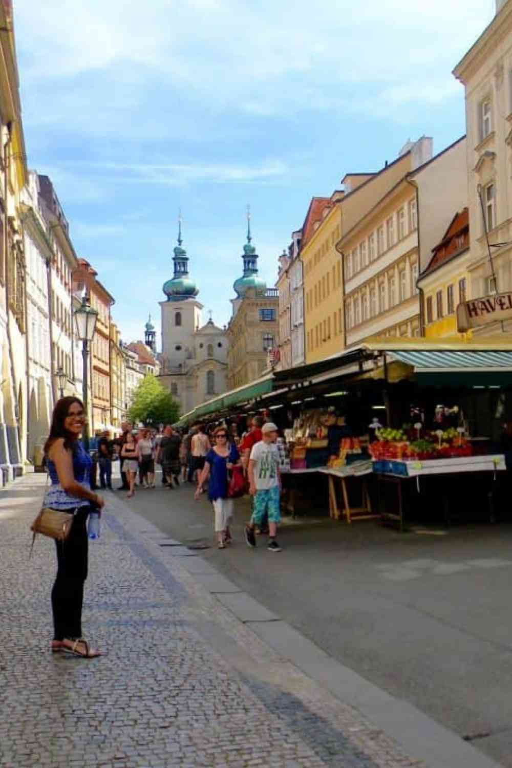 girl walking in Prague, Czech Republic towards a fruit and vegetable outdoor market