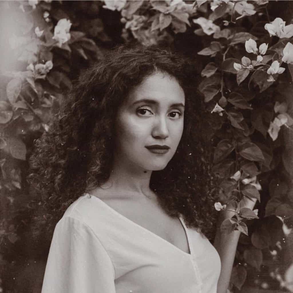 black and white picture of a girl with curly black hair