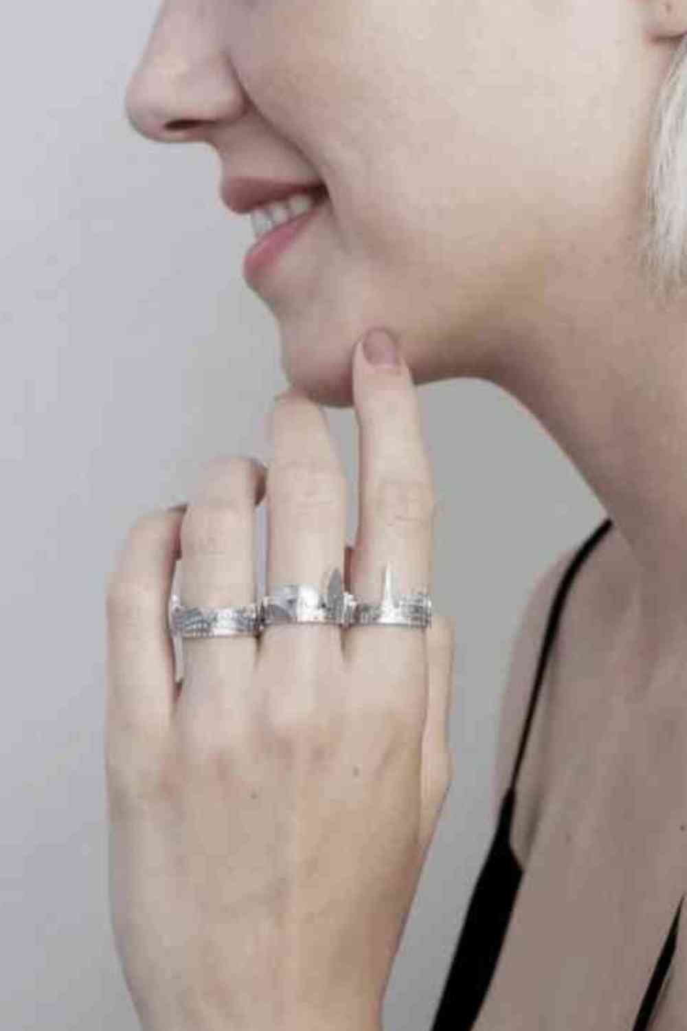 girl wearing a ring with different cities