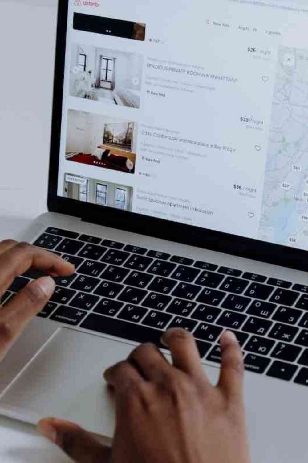 woman typing on her laptop looking for hotels and vacation rentals