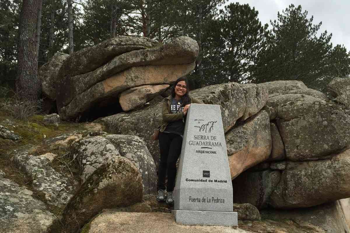 Manzanares El Real, madrid, spain girl standing next to hiking marker