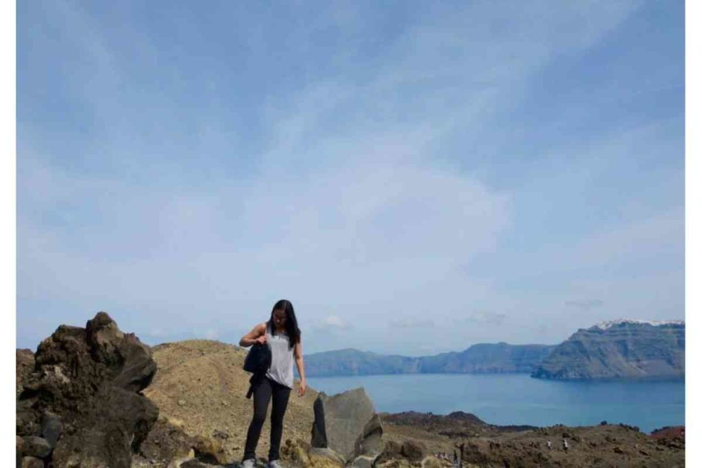 girl with grey shirt standing on Greek island in Greece