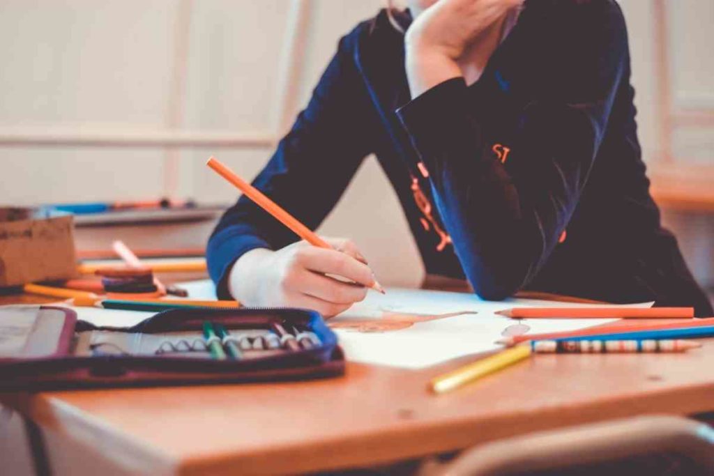 a teacher writing down notes