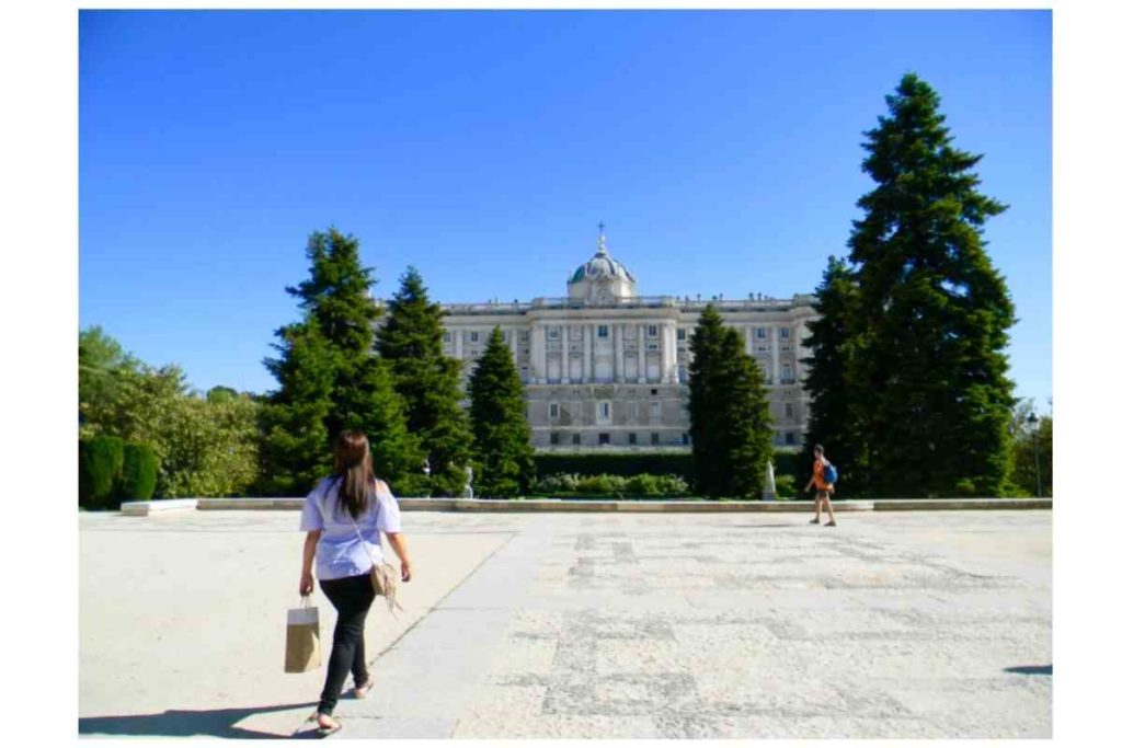 girl walking around the royal palace of madrid, spain