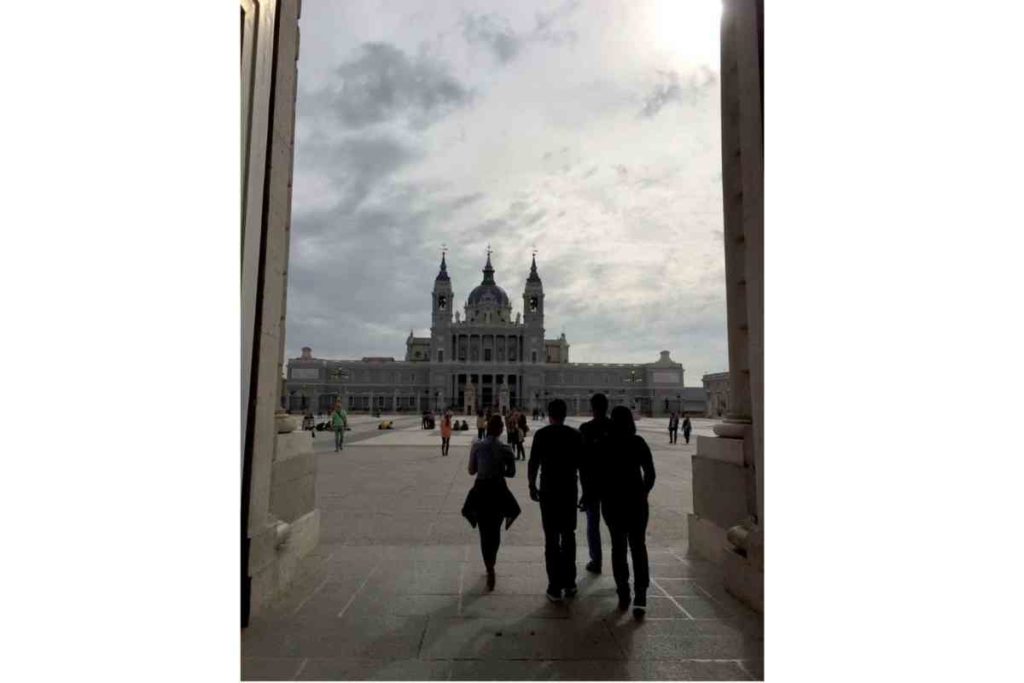 People walking around the royal palace of madrid, spain