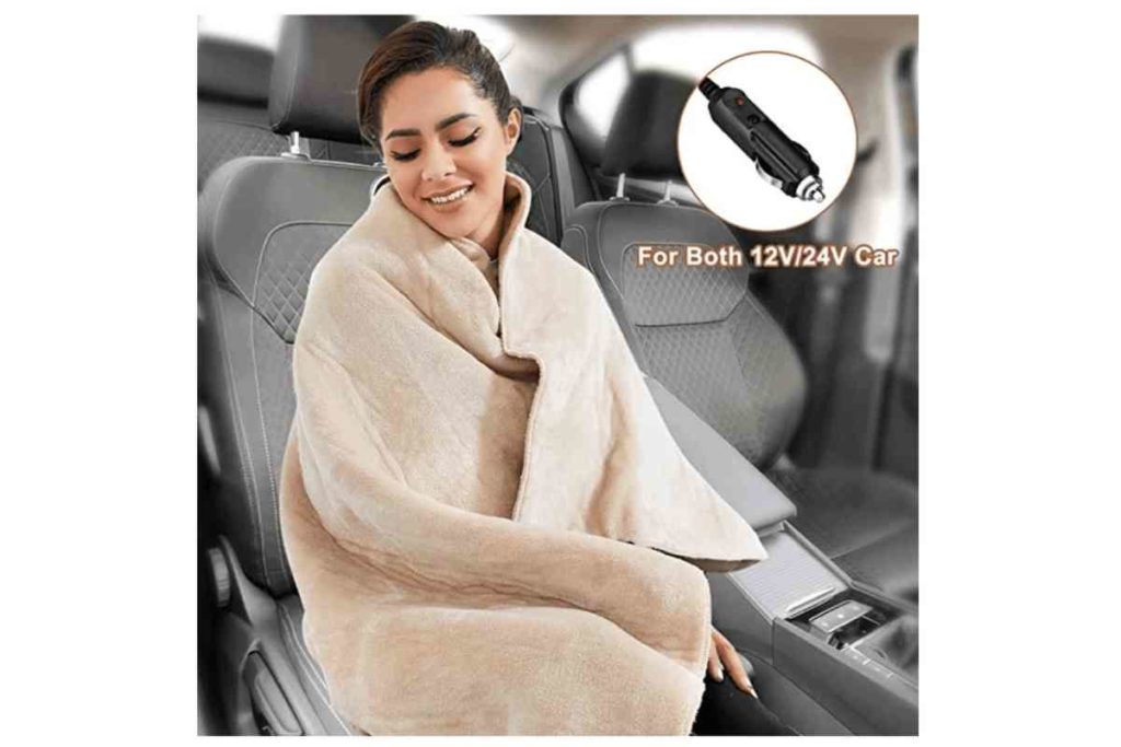 car accessory woman wrapped in beige electric car blanket Car Accessories For Your Next Road Trip