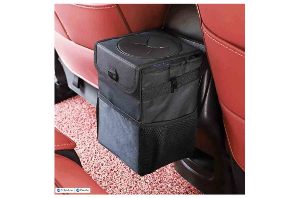 car accessory portable black garbage bin in a red car Car Accessories For Your Next Road Trip