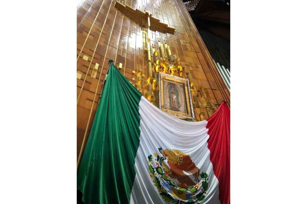 The Virgin Mary altar with gold and the Mexican flag inside the basilica de Guadalupe in Mexico City