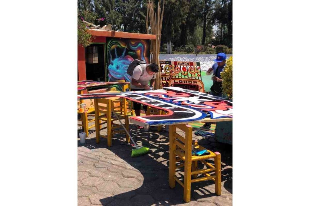 man hand painting a trajinera in Xochimilco Mexico CIty