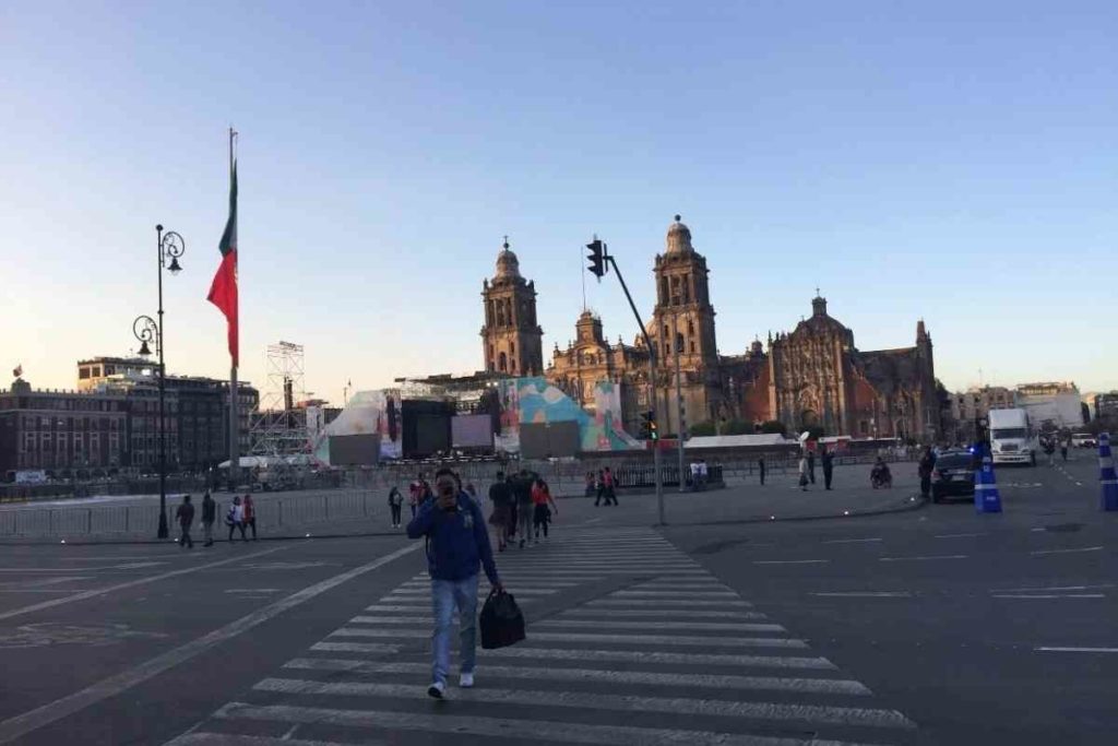 people walking around el Zocalo in Mexico City in the early evening