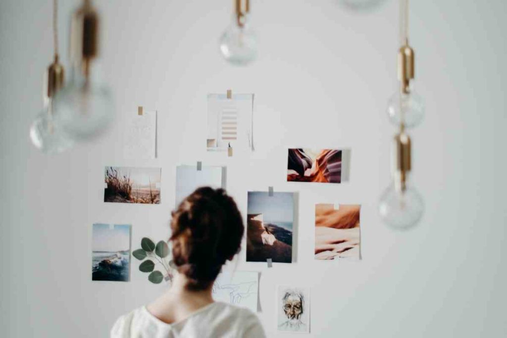 girl looking at photos on a wall