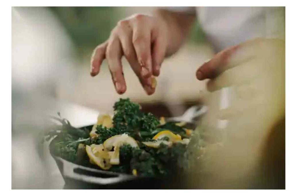 girl cooking with kale on the stovetop