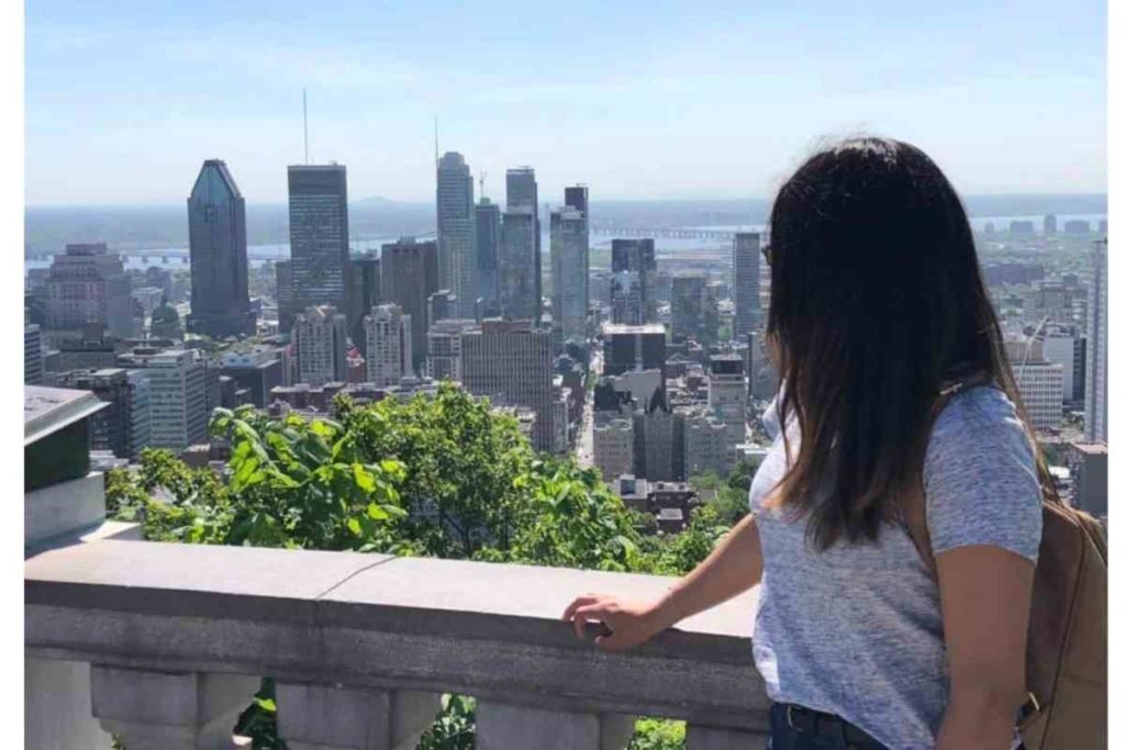 girl with grey shirt looking out to montreal skyline