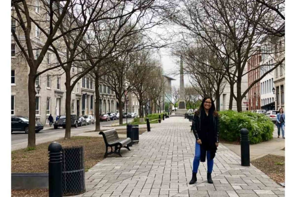 girl standing in cobble street in montreal