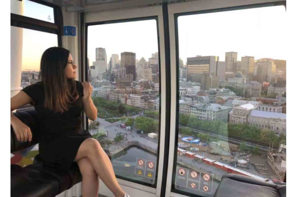 girl sitting inside ferris wheel in montreal canada