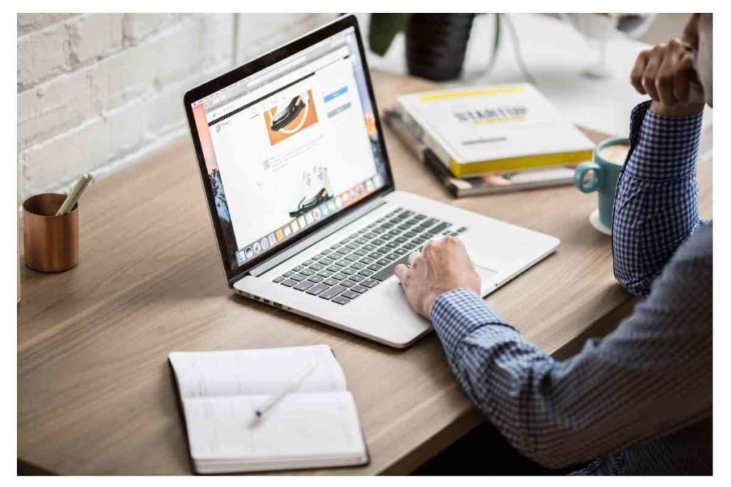 person looking at the computer working and being busy