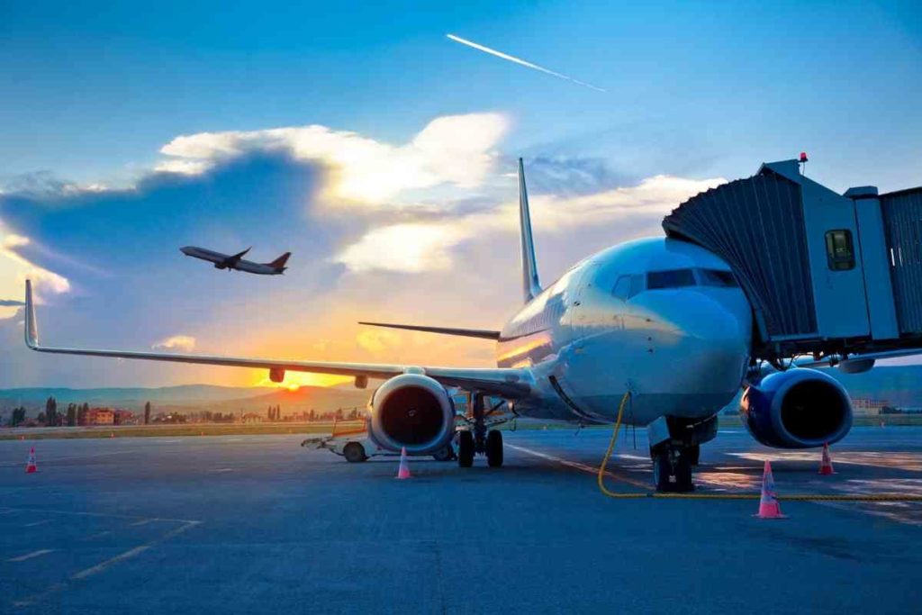 airplane at sunset boarding at an airport