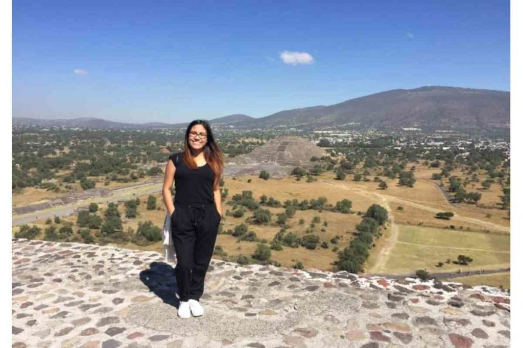 girl with black shirt and black pants standing on top of teotihuacan, mexico city