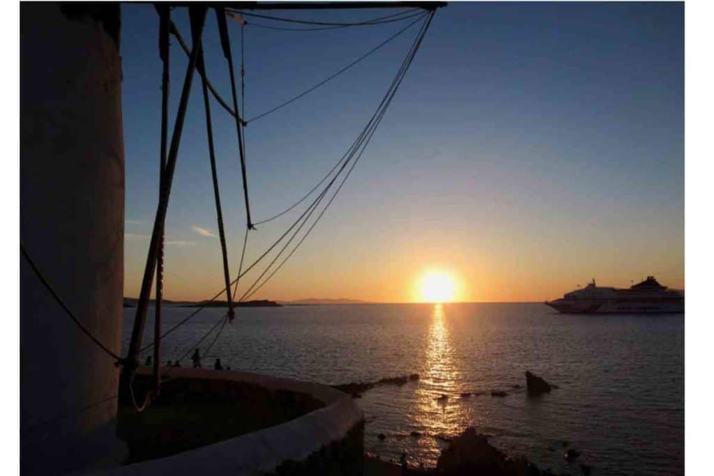 sunset in mykonos, greece on the sea