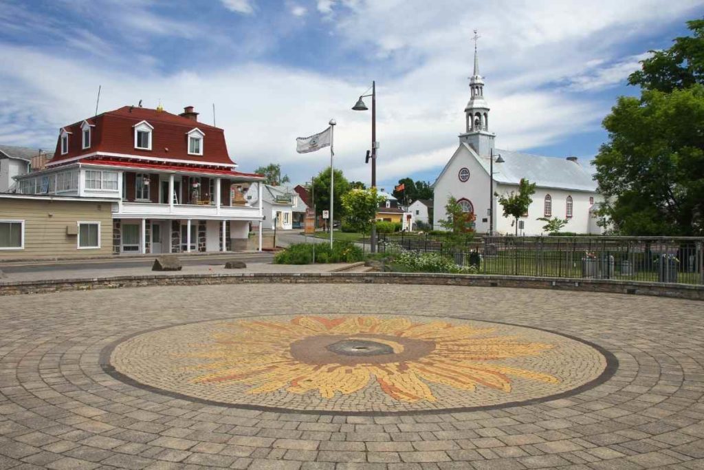 Town of Wendake town square with a drawing of a sunflower on the floor.
