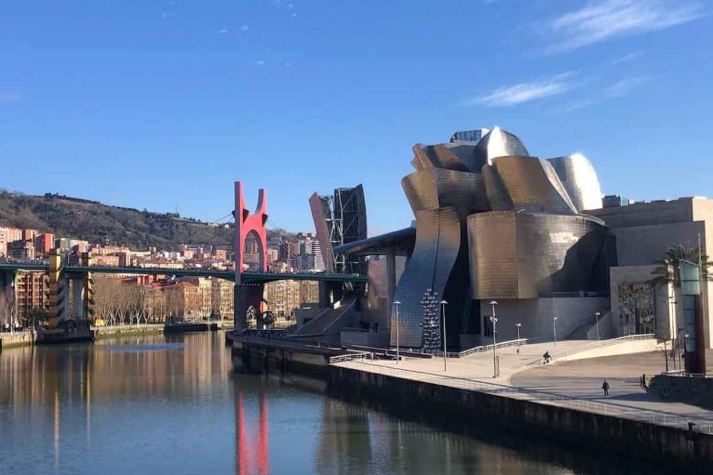 The Guggenheim Museum, the La Salve Bridge also known as the Prince and Princess of Spain Bridge, the Nervion River on a sunny day in Bilbao