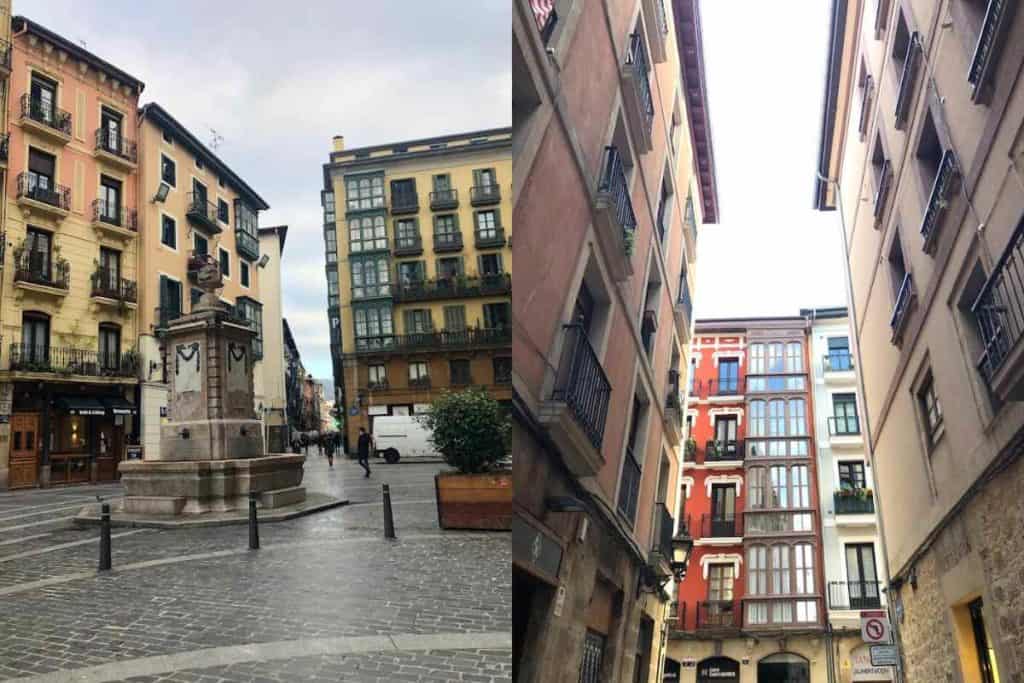 The streets of the historic center of BIlbao with historic fountain, cobblestone streets, and historic apartments