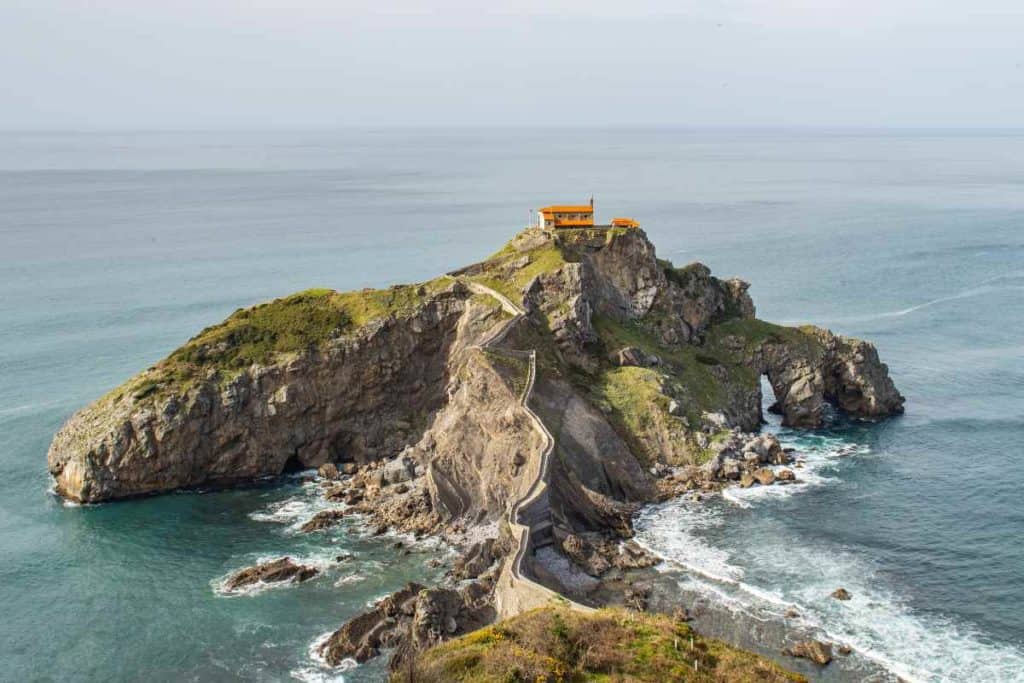 Coastal cliffs, crashing blue waves, and the hermitage of San Juan de Gaztelugatxe