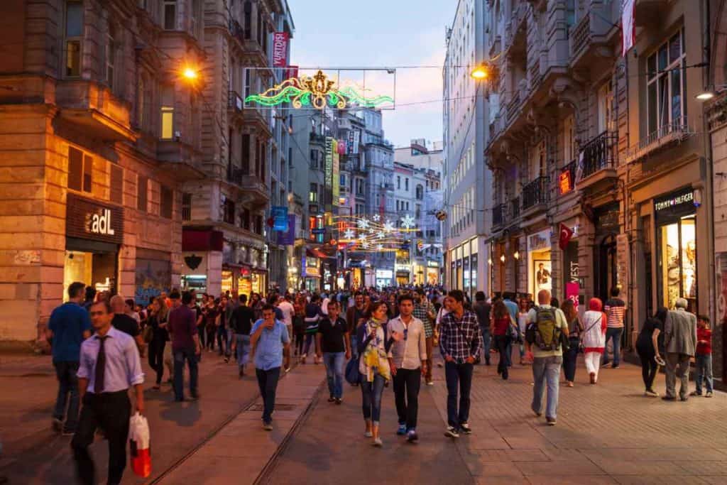Best Safety Tips as a Solo Latina Traveler people walking around on a busy street in Spain
