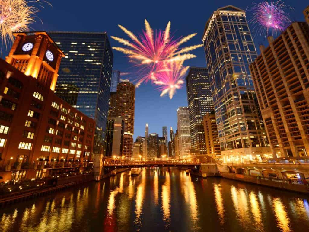 Bright fireworks over the city of Chicago and the Chicago river at night