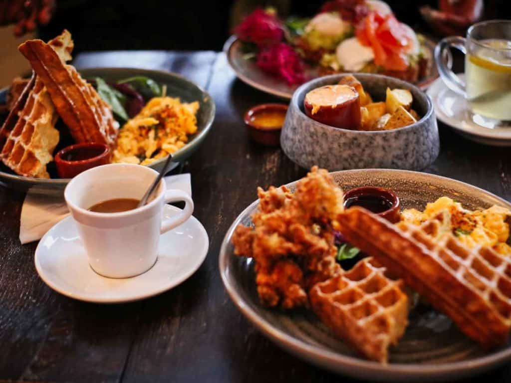 Brunch spread with waffles, coffee, fruit, and eggs