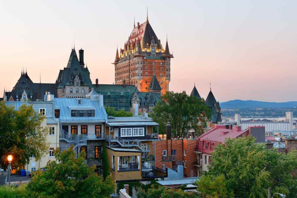 A panoramic view of Old Quebec City with the iconic Château Frontenac at sunset, a top destination for historic day trips from Montreal.